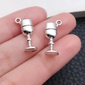 Silver alloy wine glass pendant for necklaces and bracelets shown on fingertips - Wine Goblet Style / Antique Silver (10562)