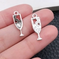 Antique silver wine glass charms for DIY jewelry making shown in hand for scale - Wine Goblet Style / Antique Silver (10565)
