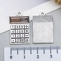 Macro shot of silver alloy calculator charm detail for DIY necklaces or bracelets - Stationery Calculator Style (21419)