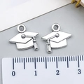 Silver graduation cap pendant charm shown with a ruler for 1.5cm size measurement - Bachelor's Cap Style (21427)
