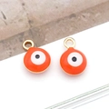 Close-up of 6mm orange evil eye charms with gold metal rings for DIY jewelry - Small Round / Orange