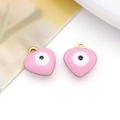 Close-up of heart-shaped double-sided enamel charms with evil eye design and gold loops - Heart / Pink