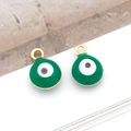 Macro shot of two circular 6mm green evil eye charms with gold plated round metal buckles - Small Round / Green