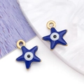 Macro shot of star-shaped evil eye pendants in deep blue enamel with gold plated edges - Pentagram / Blue