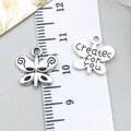 Detailed macro view of retro silver butterfly charms showing size and created for you text - Created For You Butterfly (10356)