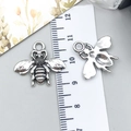 Silver bee pendant charm detail with wing texture and size measurement on scale - Bee (9188)