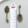 Macro detail of bronze alloy key pendants with crown and bow motifs for DIY jewelry - Crown Key Style (3884) / 1.7cmx5.9cm