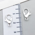 Silver metal lobster clasps for DIY jewelry making measured with a 12mm ruler scale - Bright Silver