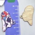 Detail eines Herzanhängers mit lila Graffiti-Farbmuster und goldener Rückseitenstruktur - Violett-weißer Druck Cowboyhut (23762)
