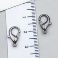 Gunmetal alloy lobster clasp for DIY jewelry with size reference on a ruler - Gunmetal