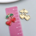 Detail view of heart-shaped cherry pendant charms with red enamel and gold finish - 1Pc KC Gold Red Enamel Heart Shape Cherry (23443)