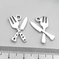 Vintage silver cutlery charm featuring a crossed spoon and fork design for DIY jewelry - Crossed Knife and Fork (8834)