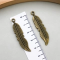 Vintage bronze feather alloy charm pendant with detailed texture for DIY jewelry making - Antique Bronze (1069)