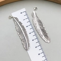 Vintage silver feather pendants in zinc alloy showing 4.8cm length on a ruler - Antique Silver (6262)