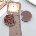 Detailed macro view of resin biscuit pendant with realistic cream filling and metal loop - Coffee Resin Biscuit (23819)