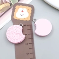 Detail view of pink resin biscuit pendant with realistic bite mark and ruler for size - Pink Resin Biscuit (23820)