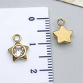 Detailed view of a 10mm golden star pendant with white rhinestones next to a scale ruler - Gold Five-Pointed Star (T2394)