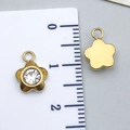 Detail of 10mm golden flower charm with white zircon and smooth mirror back finish - Gold Plum Blossom (T2395)