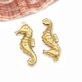 Detailed close-up of a pair of golden seahorse-shaped metal jewelry pendants for necklaces - Seahorse (T1965)
