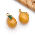 Vue macro de pendentifs œufs dorés avec détail de feuille verte et fini brillant - Pendentif Mangue 3D Jaune Transparente - Slim (T1605)