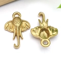 Macro view of gold elephant head charms showing front and back detail for DIY jewelry making - Animal Elephant
