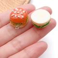 Detailed view of handmade resin mini hamburger charm with seeds and sesame details - Orange