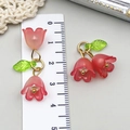 Macro detail of acrylic lily of the valley charm with pink petals and green leaf - Lily of the Valley Pendant (23261) / 1 Piece/Pack (22x20mm) / Transparent Red