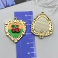 Macro view of heart-shaped cherry pendant with gold relief texture and ruby rhinestones - Yellow Green Heart Rhinestone Cherry (24435)