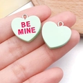 Detail view of heart-shaped resin pendants in light green with BE MINE engraving - 1.9x1.9cm (1.2g) / Green (Bemine)