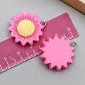 Macro shot of 3cm resin sunflower pendants in bright pink with measurement tool - Sunflower (24350) / Rose Red