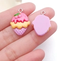 Detailed macro view of resin strawberry ice cream cone pendants with silver metal rings - Purple Base Rose Red Ice Cream Cone