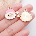 Detailed close-up of a pink Santa Claus enamel charm with gold-plated metal finish - Pink Santa Head Style