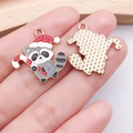 Detail of Christmas raccoon pendant showing enamel front and textured gold back - Gray Candy Cane Raccoon (25272)