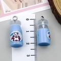 Macro shot of a light blue resin milk bottle charm showing the 22mm height measurement - 1 Piece Only (24094) / Transparent Blue
