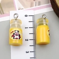 Macro view showing dimensions of yellow resin 3D milk bottle charms for DIY jewelry making - Transparent Yellow