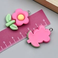 Pink resin flower charm with green leaf and yellow center, 2.5cm width variant - Light Green Leaf Plumeria (24343) / Rose Red