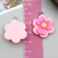 Resin pink flower pendant with yellow core and metal ring measured by ruler 30mm - Plum Blossom Style (24338)