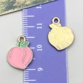 Pink enamel peach fruit pendant with golden textured back and green leaf detail - Peach Style (24413)