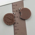 Macro view of realistic biscuit resin pendant with BISCUITS engraving and bite marks - Coffee Resin Sandwich Biscuit (23819)