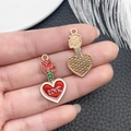 Macro shot of red enamel heart charms with gold rose detail and LOVE inscription - Red Glitter Enamel Rose Perfume Bottle Charm (21461)