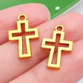 Close-up of a gold hollow cross pendant held on a finger to show its actual size - Cross Style (17607)