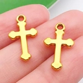 Golden alloy cross charms for DIY jewelry held by hand to show actual size - Cross Style (20369)