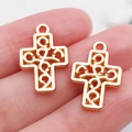 Handheld view of a hollowed vintage cross pendant in golden finish for DIY jewelry - 1pc Hollow Cross 19x13mm (20334)