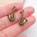 Macro detail of antique bronze saxophone pendants for DIY jewelry making accessories - Saxophone (20897)