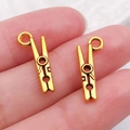 DIY jewelry making supplies featuring two gold mini clothespin alloy charms with hanging loops - Clip 7x18mm (20241)