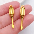 DIY gold screwdriver alloy charms for necklaces and keychains shown in hand - Screwdriver 31x6mm (20393)
