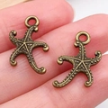 Pendentifs étoile de mer en alliage bronze antique pour bijoux DIY présentés sur la main - Style Étoile de Mer (20722)