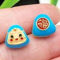 Macro view of blue Daruma and Fu character enamel triangle charms with gold-plated edges - Blue Large Straight Hole Smiley Zongzi Bead (22594)