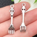 Pair of silver skull-handled fork pendants in polished alloy for DIY jewelry - Tableware Fork (9x36mm)