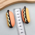 Miniature PVC hot dog pendant accessory for DIY keychains and bags shown with ruler - Orange Simulation Sausage Hotdog